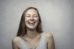 Photo by Andrea Piacquadio: https://www.pexels.com/photo/woman-in-gray-tank-top-laughing-3812740/ Happy teenage girl smiling with braces.