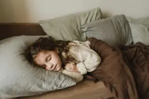 Photo by Arina Krasnikova: https://www.pexels.com/photo/young-girl-sleeping-in-a-sofa-5119824/ Young female child sleeping on her side 