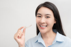 woman with Invisalign aligner orthodontic concept