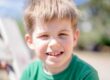 Photo by Atlantic Ambience: https://www.pexels.com/photo/boy-in-green-crew-neck-shirt-smiling-12969391/ boy smiling with baby teeth