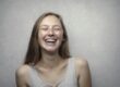 Photo by Andrea Piacquadio: https://www.pexels.com/photo/woman-in-gray-tank-top-laughing-3812740/ Happy teenage girl smiling with braces.