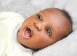 Image URL: Photo by Ayobami Adepoju: https://www.pexels.com/photo/baby-with-mouth-open-17471734/ Alt Text: A smiling infant post frenectomy in Mansfield TX