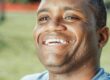 Photo by Kindel Media: https://www.pexels.com/photo/close-up-photo-of-smiling-man-7298460/ African American man smiling