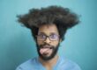 https://www.pexels.com/photo/man-in-blue-crew-neck-shirt-wearing-black-framed-eyeglasses-3914131/ African American male wearing glasses and sticking his tongue out to the side